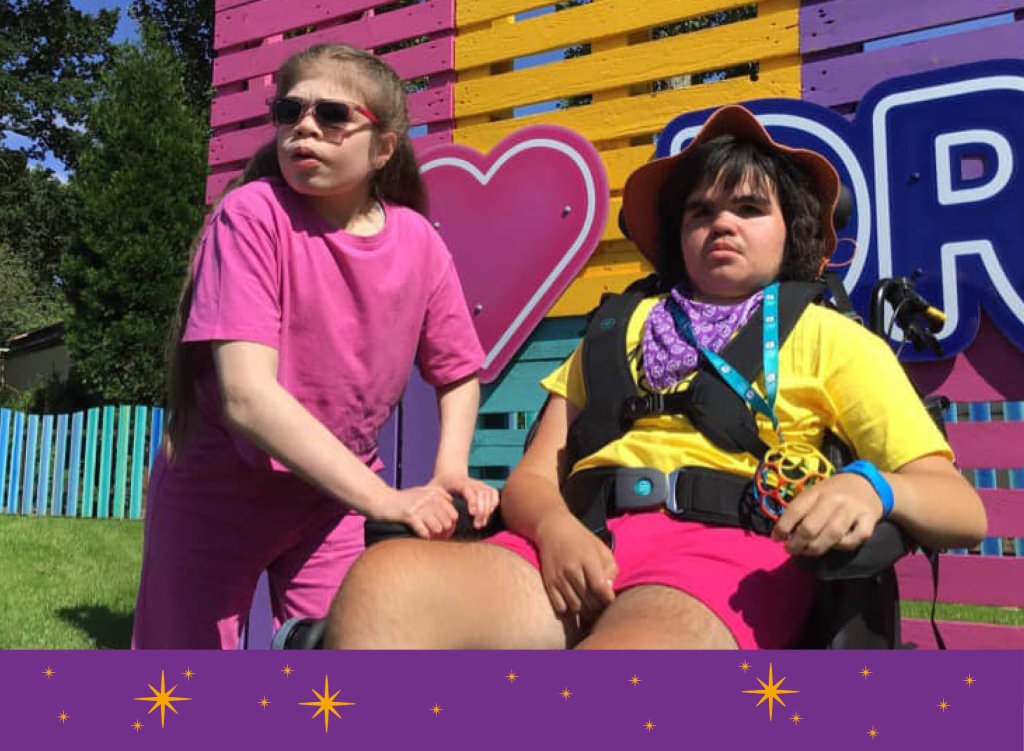 Tillie Mae and her friend in front of an I heart Drayton Manor sign.