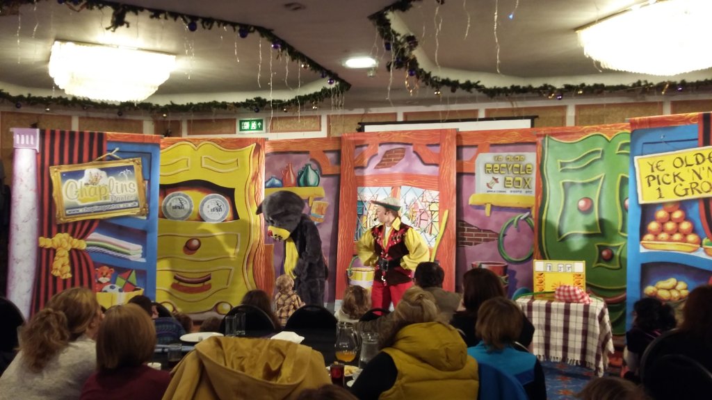 Audience watches pantomime actors perform at a hotel.