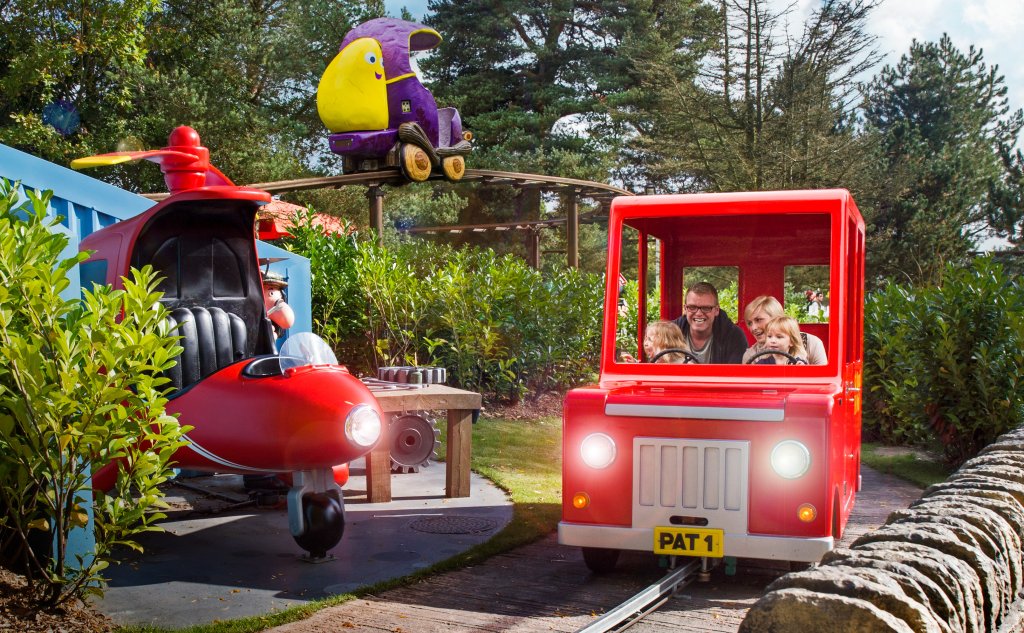 Mum, dad and two children on the Postman Pat ride at Alton Towers.
