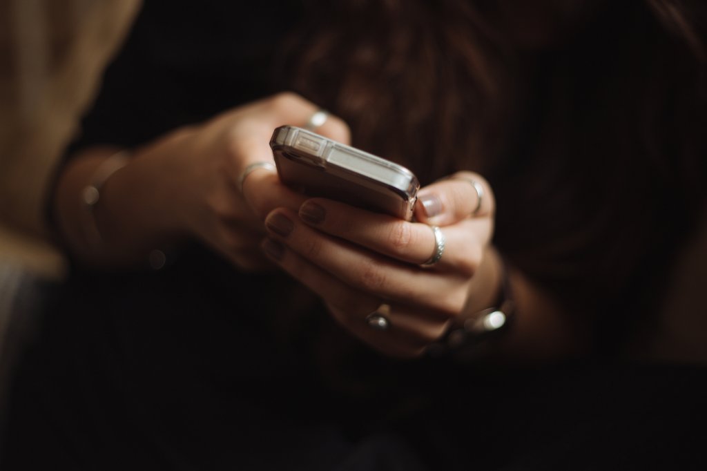 Hands holding phone.
